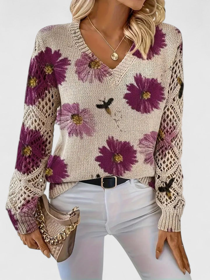 Cardigan donna primaverile a fantasia floreale, con maniche traforate per uno stile femminile e versatile.