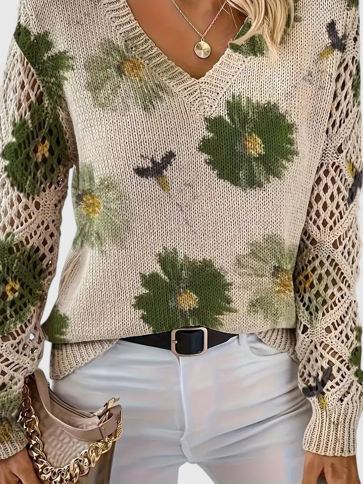 Cardigan donna elegante a fantasia floreale con dettagli di maniche traforate, perfetto per un look primaverile.