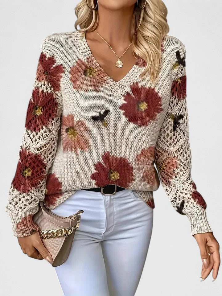 Cardigan donna con maniche traforate e vivace fantasia floreale, ideale per la stagione primaverile.