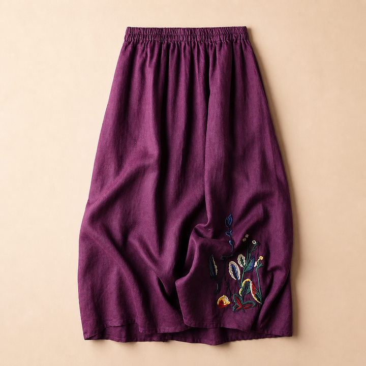 Dettagli ricamati su gonna midi donna elegante con vita elastica. Abbigliamento estivo versatile e confortevole.
