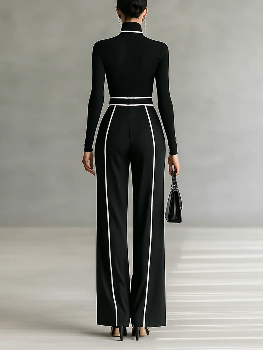 Completo due pezzi donna chic nero con profili a contrasto, dolcevita e pantaloni. Ideale per look ufficio moderno.