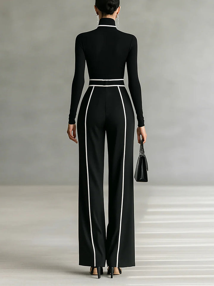 Completo due pezzi donna chic nero con profili a contrasto, dolcevita e pantaloni. Ideale per look ufficio moderno.