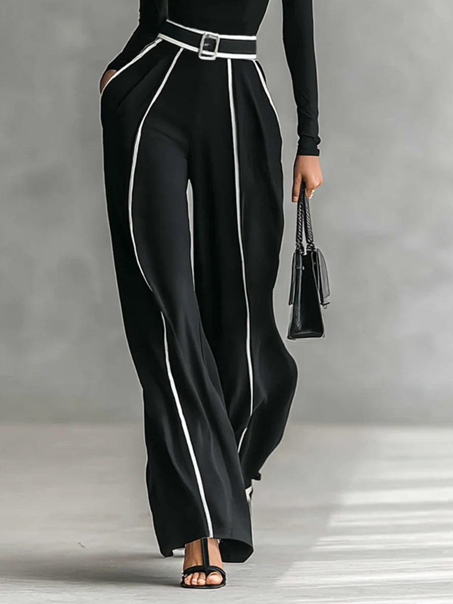 Completo elegante donna nero con maglia dolcevita e pantaloni a gamba larga. Abbigliamento versatile per ogni occasione.