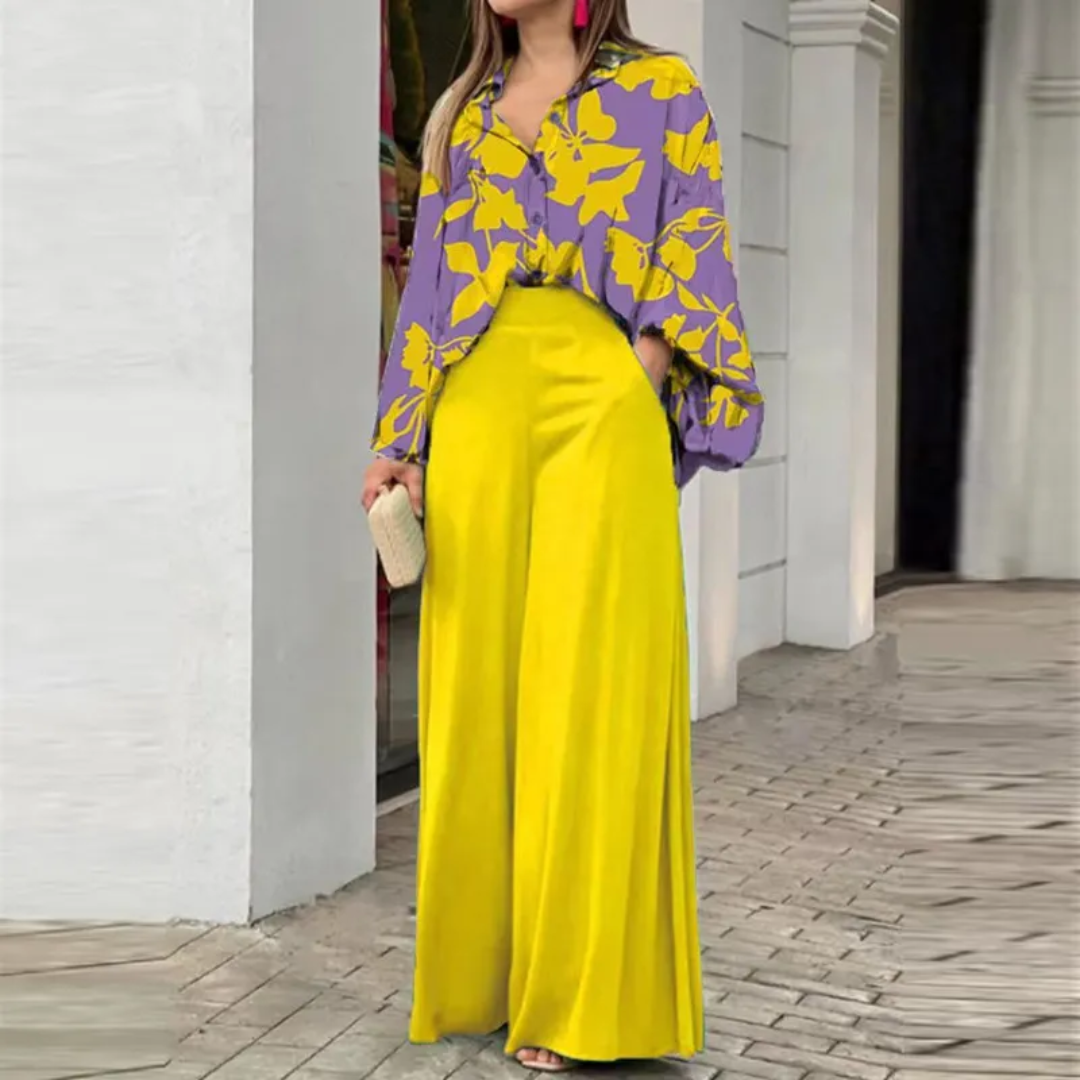 Completo donna 2 pezzi con vivace camicia stampata e pantaloni larghi fluidi. Perfetto per un look casual elegante.
