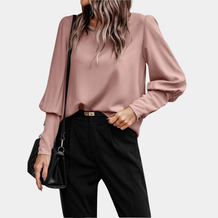 Elegante blusa da donna a maniche lunghe, con maniche a palloncino. Top moderno per moda femminile, outfit versatile.