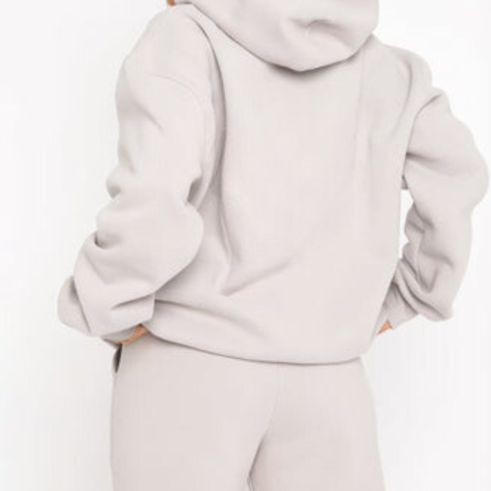 Completo tuta donna con cappuccio, ideale come set sportivo o abbigliamento relax a casa.