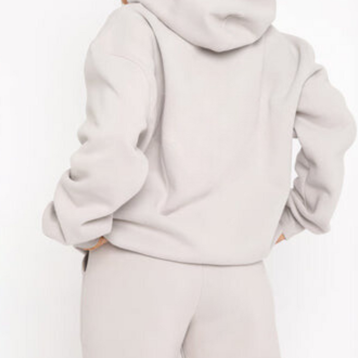 Completo tuta donna con cappuccio, ideale come set sportivo o abbigliamento relax a casa.