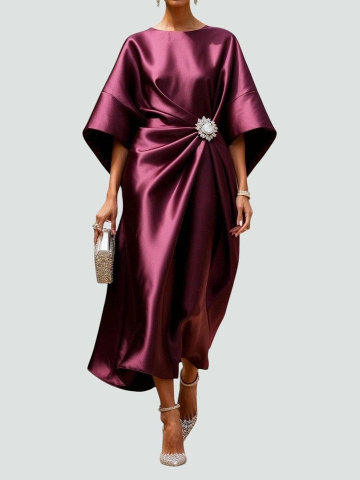 Vestito lungo rosso scuro per donna, drappeggiato, con spacco e prezioso dettaglio gioiello. Look da sera.