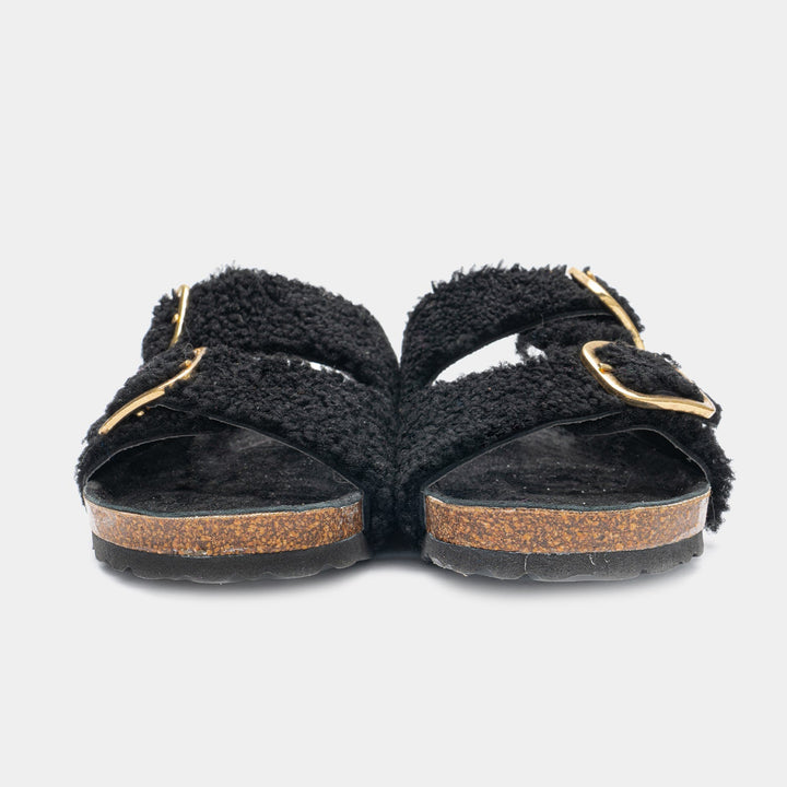 Comode slipper da donna nere con doppia fibbia regolabile, perfette per uno stile casual e rilassato.