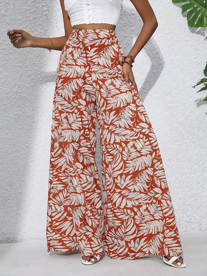 Pantaloni palazzo floreali donna, vestibilità ampia e vita alta, ideali per un look estivo elegante e fluido.