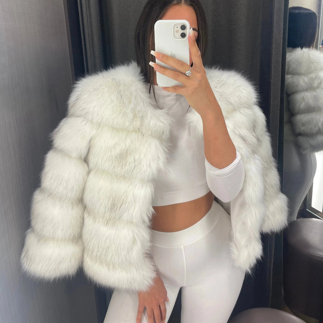 Primo piano del collo tondo della giacca corta in pelliccia sintetica da donna. Dettaglio elegante e caldo.