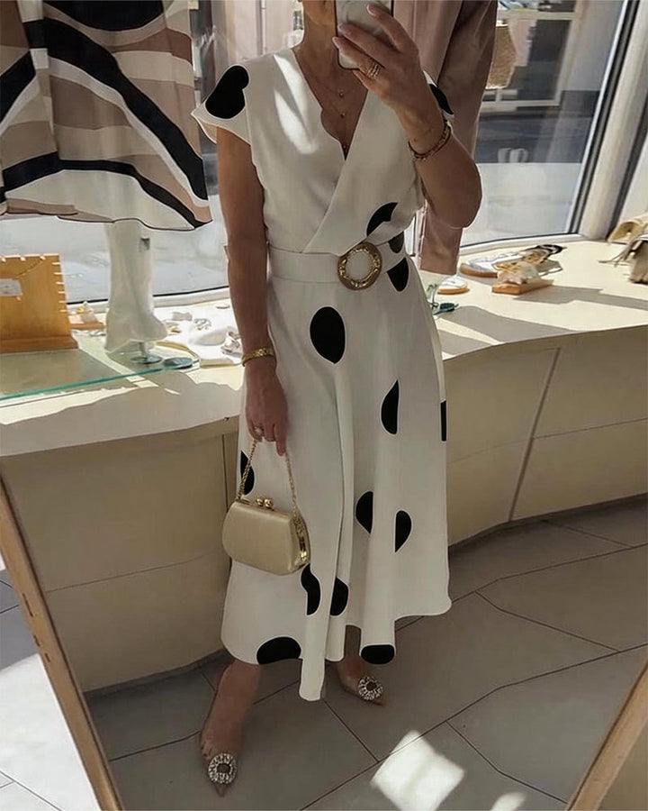 Abito midi da donna a pois con scollo a V, vestibilità comoda ed elegante. Perfetto per l'ufficio o eventi.