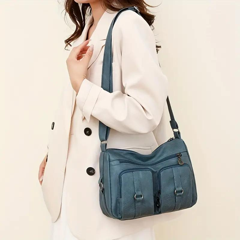 Borsa a tracolla donna frontale, con zip e tasche funzionali, stile moderno e pratico per l'organizzazione.