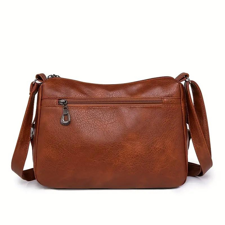 Dettaglio tasche esterne: borsa a tracolla donna multitasche, funzionale per organizzazione, accessorio moda.