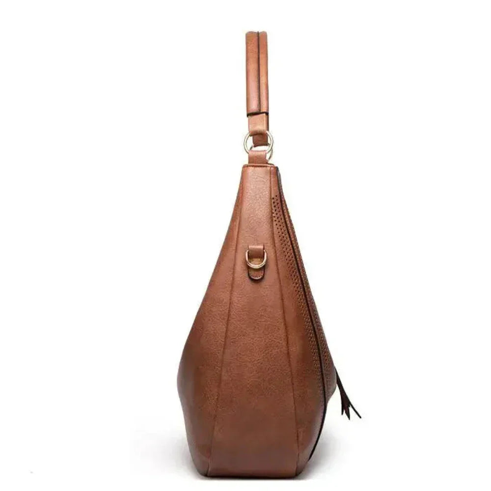 Borsa tracolla donna versatile in velluto a coste e pelle vegana, con dettagli nappine chic e trendy.