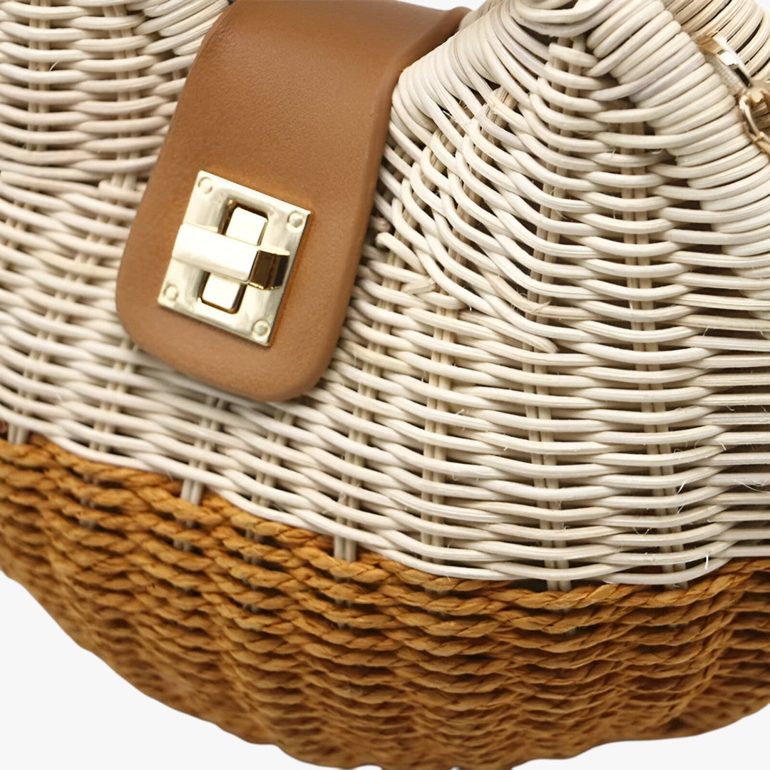 Borsa donna in paglia rotonda, con raffinata tracolla a catena, ideale per un outfit estivo.