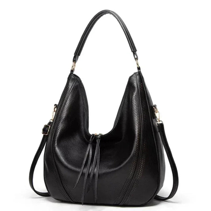 Borsa a tracolla da donna in velluto a coste con nappine, accessorio versatile ed elegante per ogni stagione.