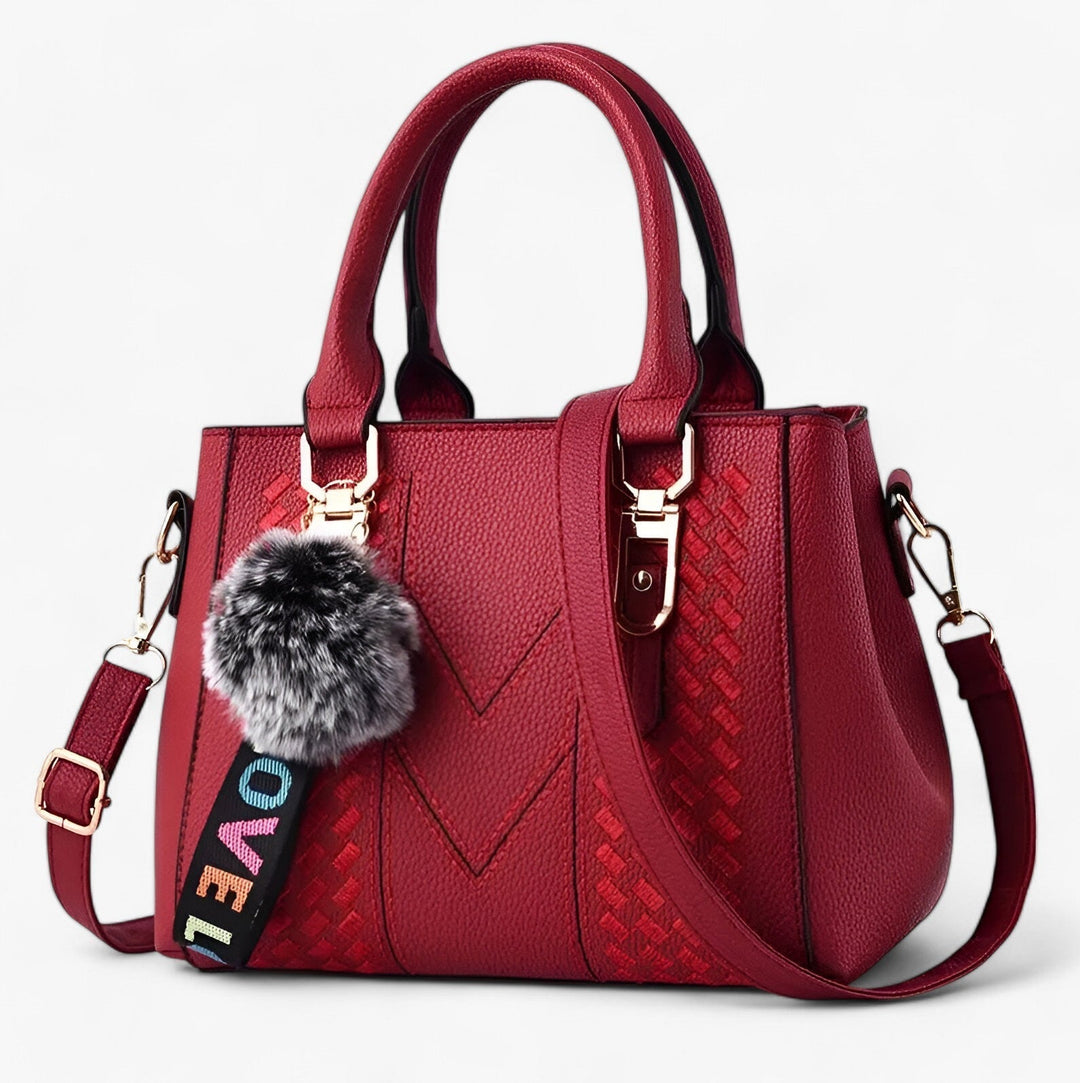 Borsa donna elegante con pompon e tracolla, accessorio versatile in pelle PU.