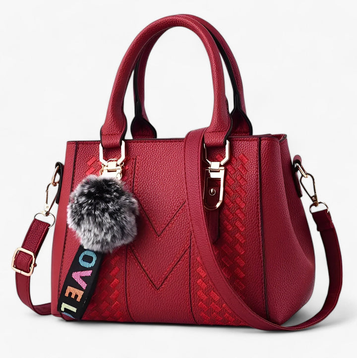 Borsa donna elegante con pompon e tracolla, accessorio versatile in pelle PU.