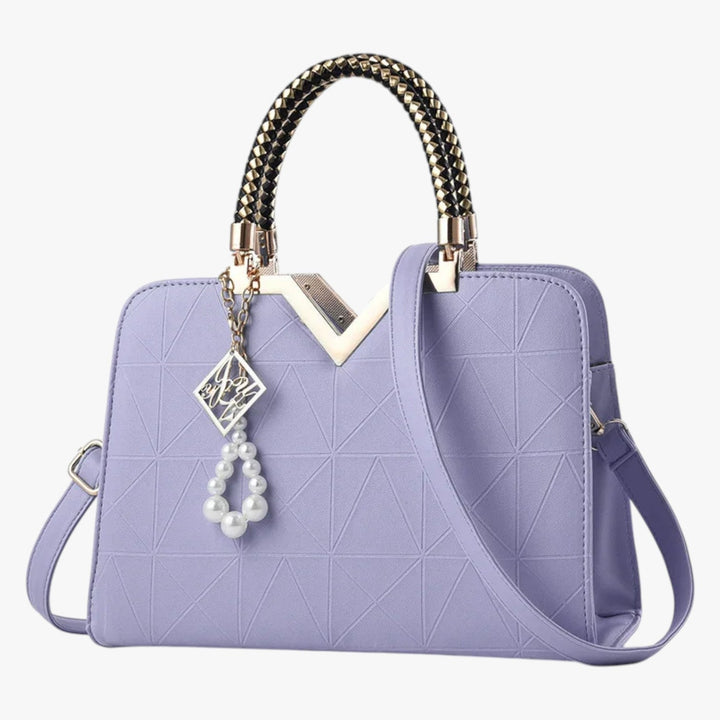 Elegante borsa a mano da donna con manici gioiello. Complemento perfetto per outfit serali.