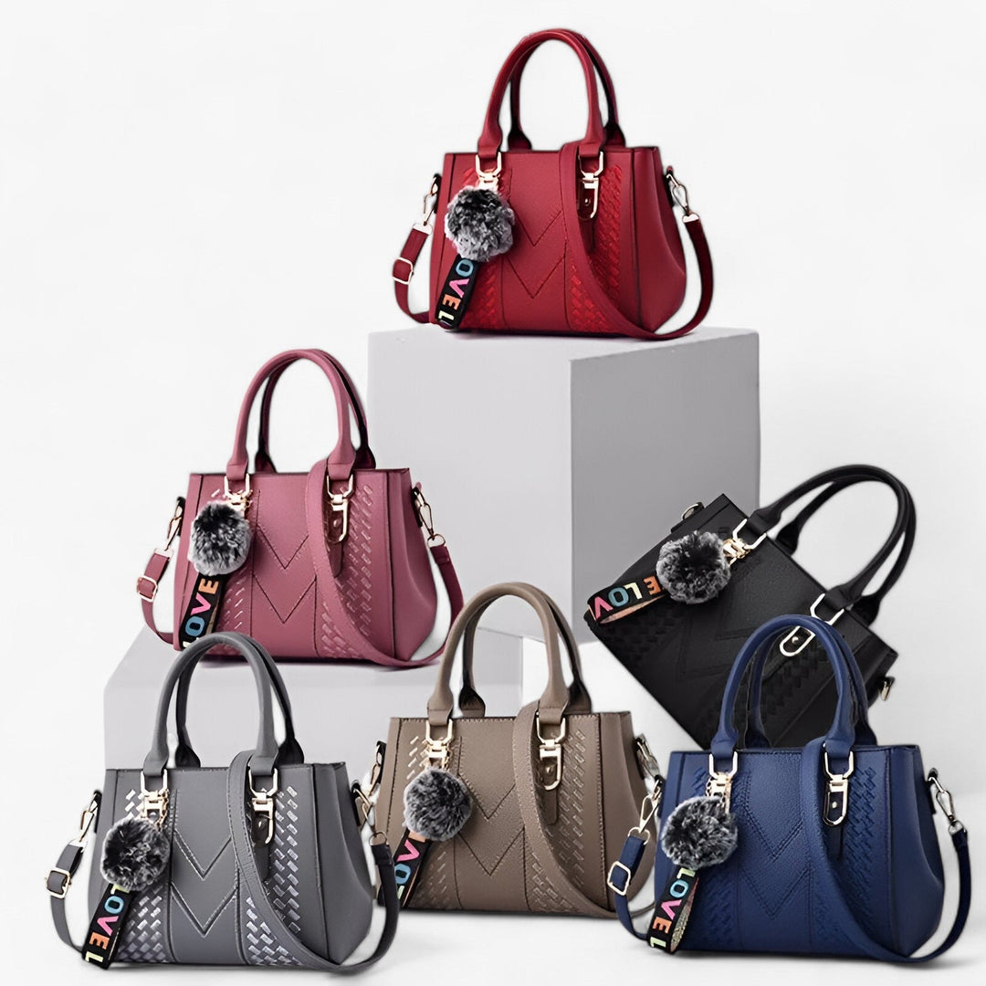 Borsa donna in pelle PU di alta qualità con manici e tracolla, abbellita da un pompon.