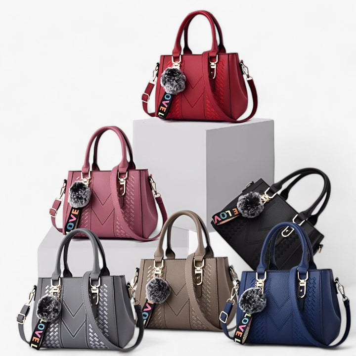 Borsa donna in pelle PU di alta qualità con manici e tracolla, abbellita da un pompon.