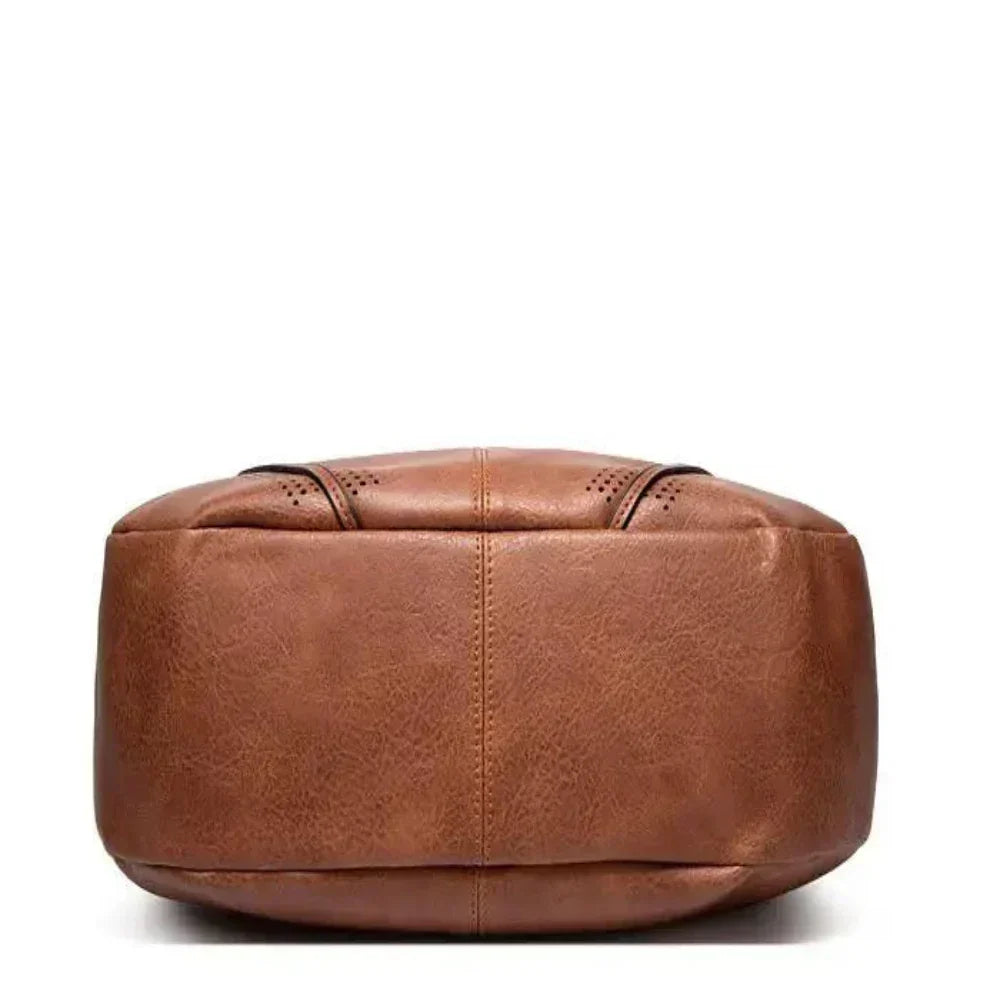 Borsa donna elegante a tracolla in velluto a coste, con finiture di lusso e nappine distintive per look sofisticati.