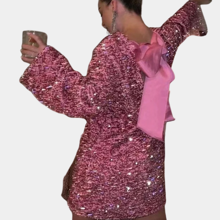 Abito elegante donna corto con paillettes metallizzate e fiocco decorativo. Perfetto per un look glamour da serata.