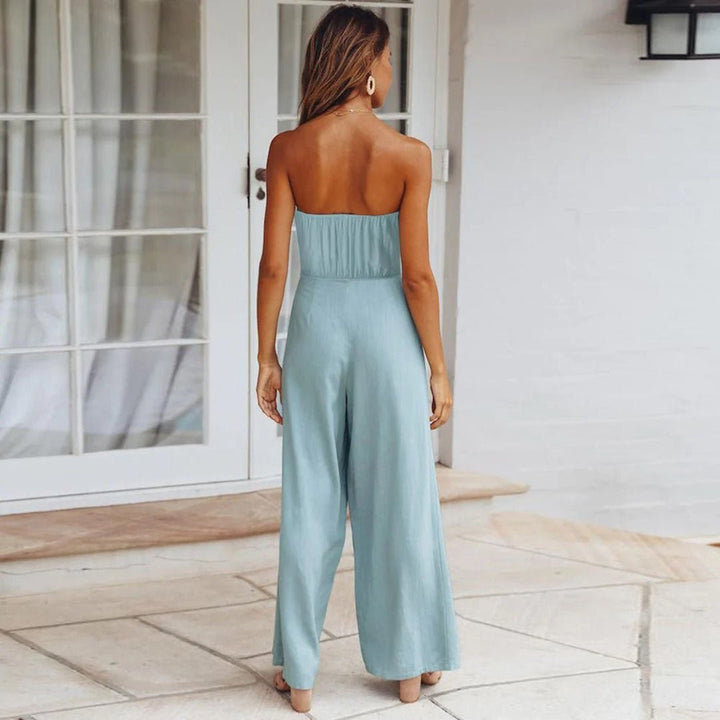 Tuta bustier donna elegante con gamba larga fluida e nodo in vita. Ideale per outfit estivi raffinati.