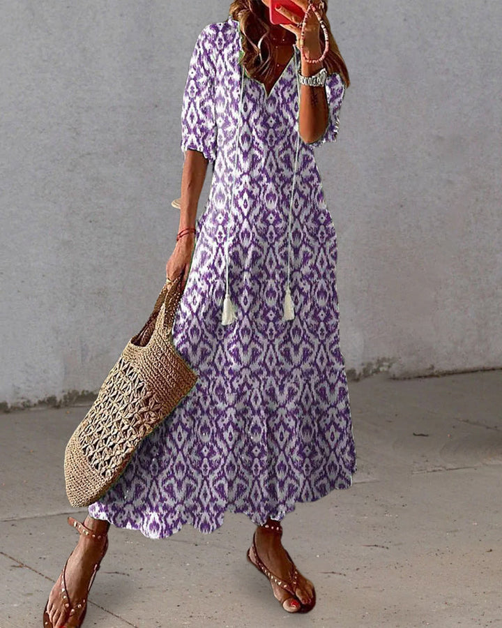 Abito donna midi estivo, stampa geometrica vivace. Scollo a V, maniche a lanterna. Look casual-chic.