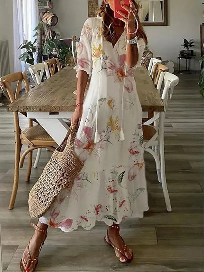 Taglio midi per abito donna con scollo a V e maniche a lanterna. Fantasia geometrica vibrante.
