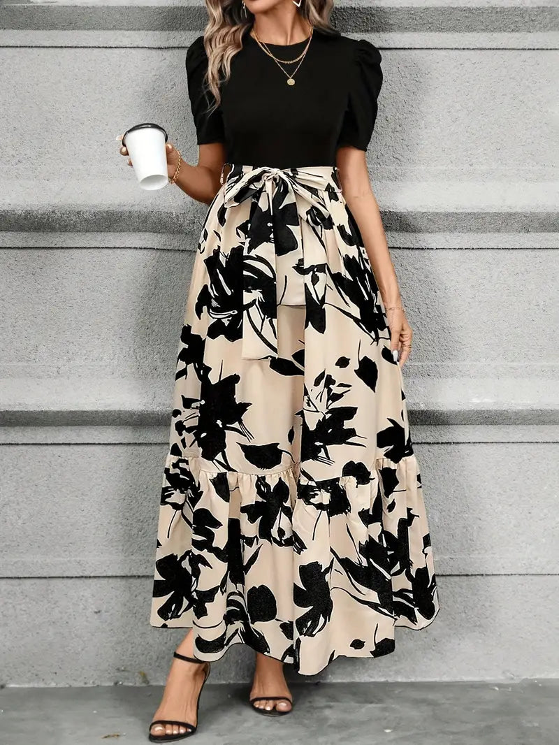 Vestito da festa lungo ed elegante da donna, con dettaglio fiocco in vita per una silhouette sofisticata e chic.