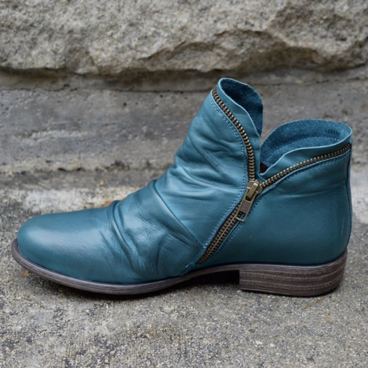 Stivaletti donna ortopedici eleganti con cerniera laterale, offrono comfort e supporto plantare, perfetti per l'inverno.