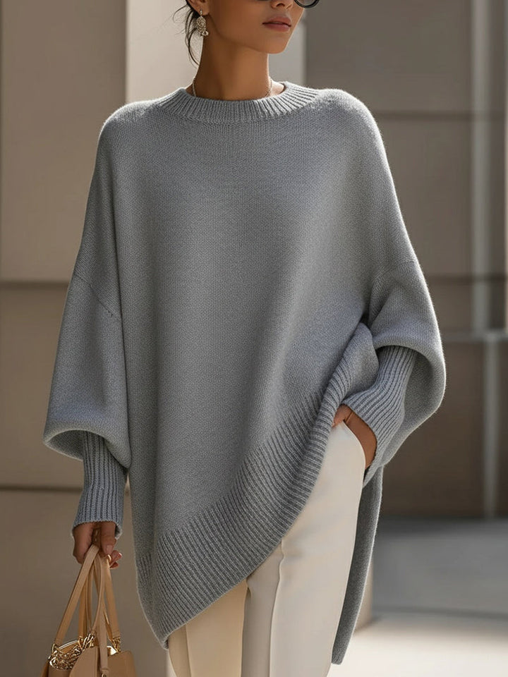 Maglione donna autunnale/invernale oversize. Design poncho con orlo asimmetrico per stile e calore.