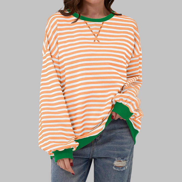 Pullover oversize donna, righe audaci e stile confortevole per la moda autunno inverno.