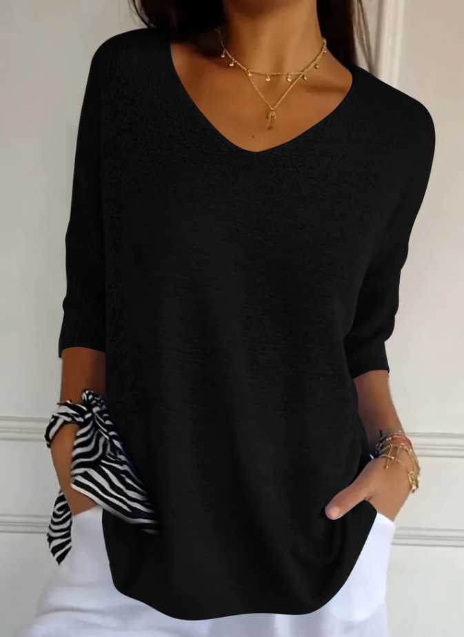 Maglione donna con maniche tre quarti, scollo a V, ideale per un look autunnale versatile e rilassato. Eleganza casual.