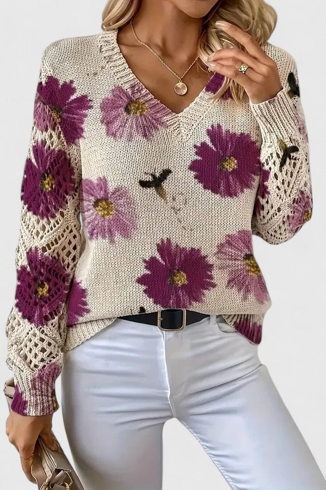 Elegante maglione floreale da donna, scollo a V e maniche traforate per un tocco di stile unico.