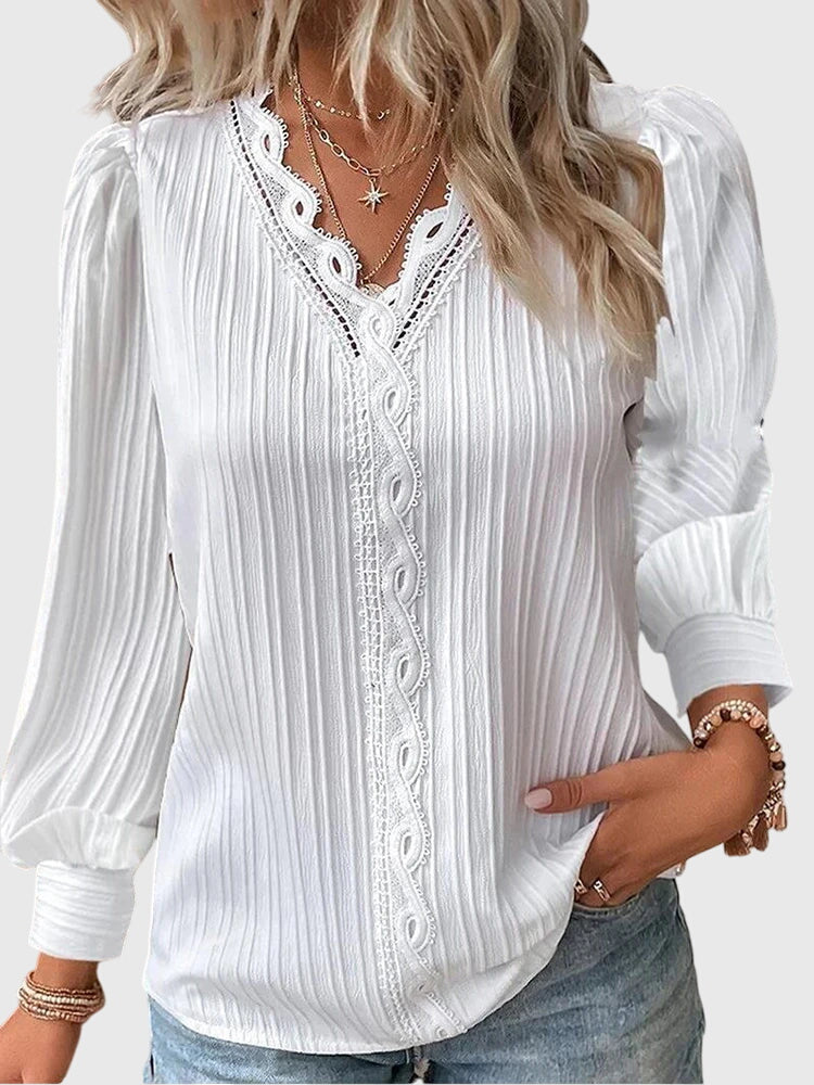 Top donna elegante a maniche lunghe, scollo a V e raffinati dettagli traforati. Perfetto per primavera/estate.