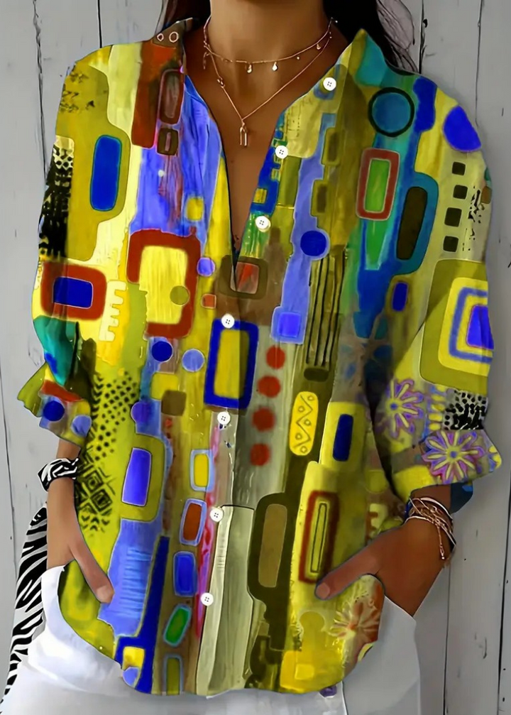 Blusa donna a maniche lunghe con stampa artistica e look vivace. Ideale per la primavera-estate, eleganza e comfort.