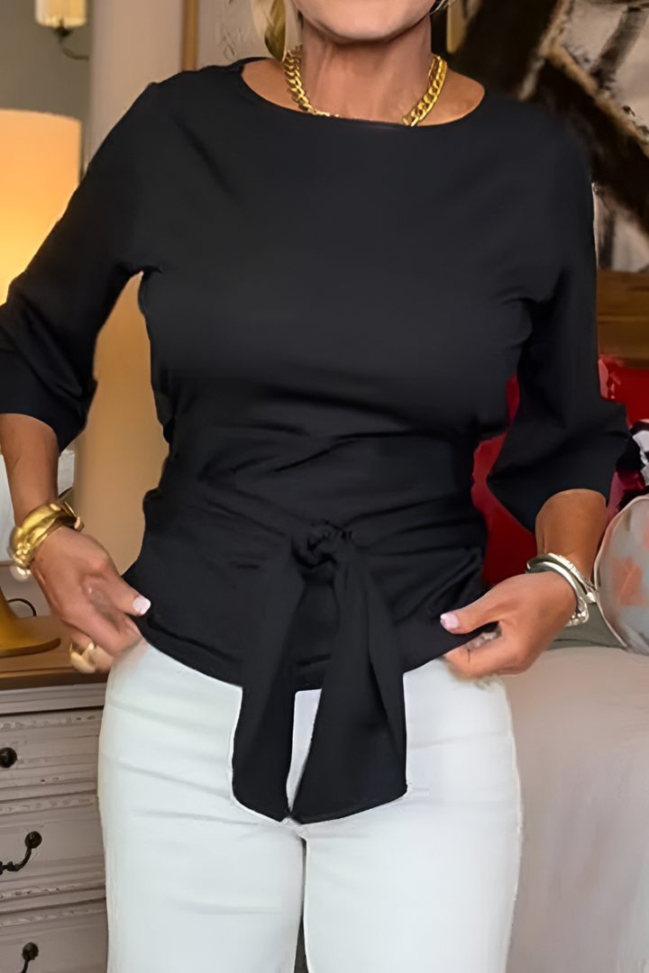 Top donna elegante a maniche lunghe con girocollo e nodo in vita. Perfetto per un look casual-chic.