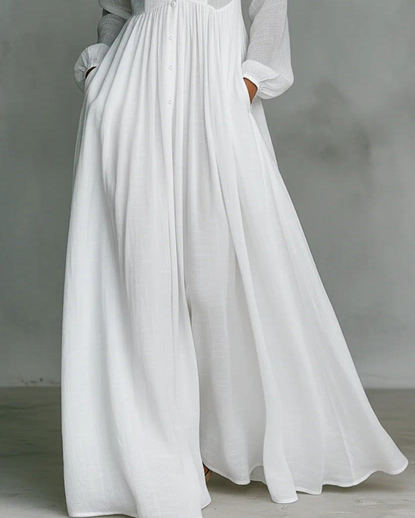 Elegante vestito donna bianco a maniche lunghe, linea fluida e bottoni frontali, un must per la moda primavera estiva.