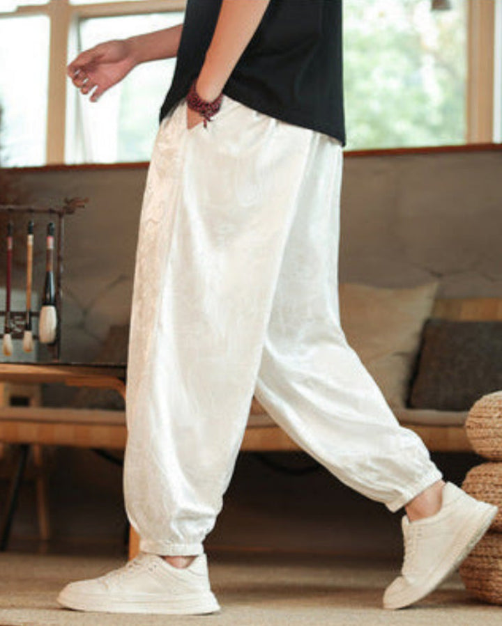 Pantaloni harem uomo neri con stampa dragone audace e coulisse. Stile casual per un look di moda uomo originale.