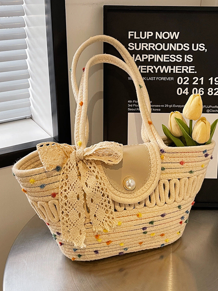 Borsa donna in paglia naturale intrecciata, con vivaci colori. Ideale come accessorio estivo per la spiaggia.