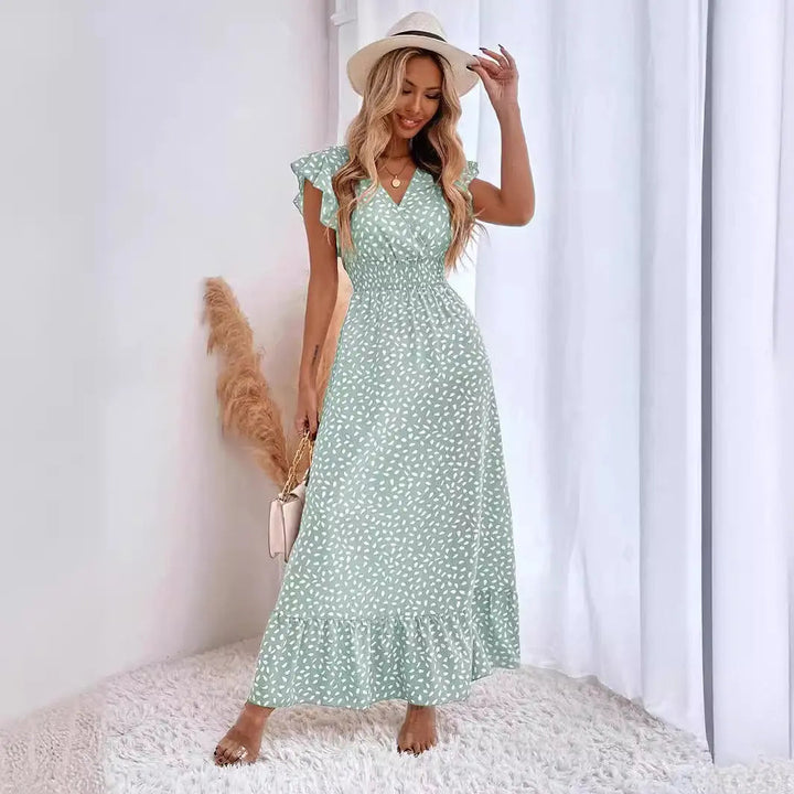 Abito donna midi estivo a pois con profondo scollo a V, maniche a volant e gonna a balze, stile chic.