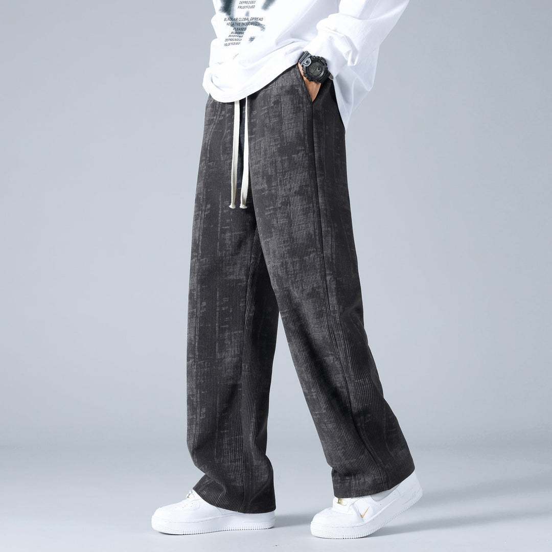 Pantaloni uomo moda autunno, in velluto a coste a coste larghe, con vita regolabile tramite cordoncino.