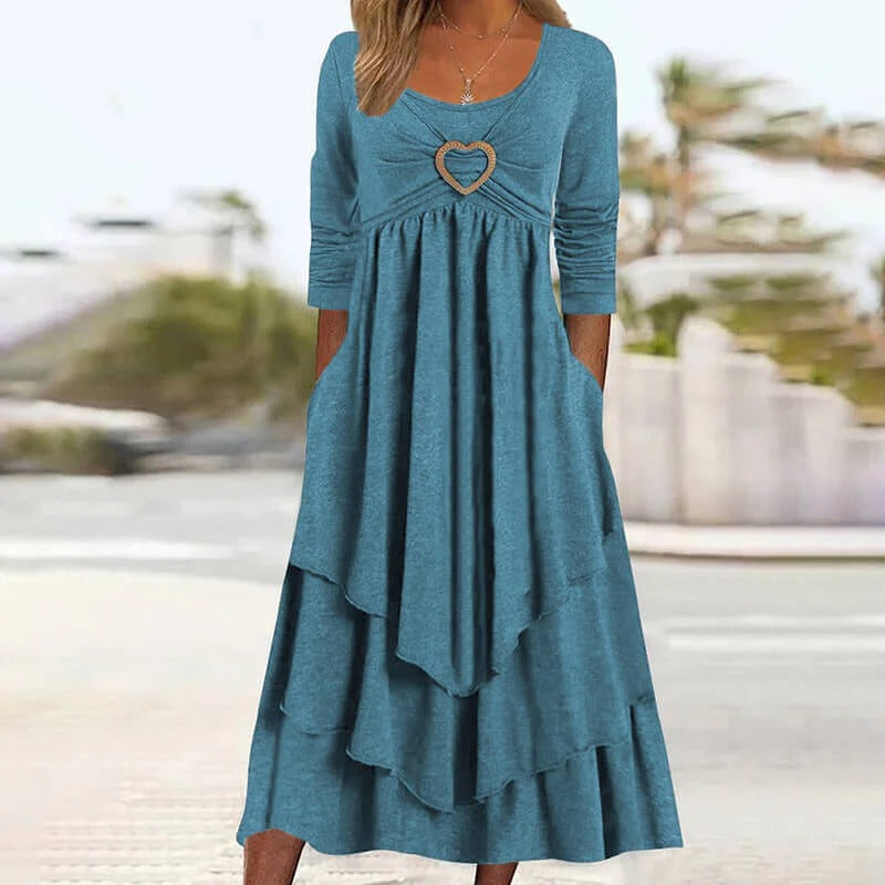 Elegante abito midi da donna, dettaglio cuore e gonna a balze. Abbigliamento primaverile Novalente.