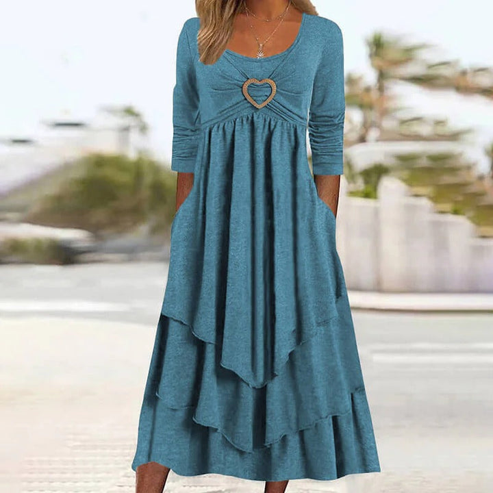 Elegante abito midi da donna, dettaglio cuore e gonna a balze. Abbigliamento primaverile Novalente.