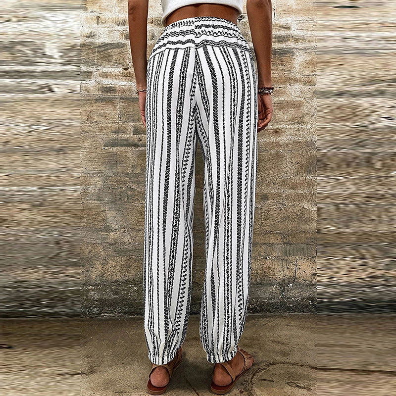 Tuta intera donna casual-elegante per l'estate, fantasia floreale e a strisce, modello a vita alta.