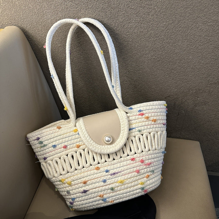 Borsa da donna colorata in paglia intrecciata. Accessorio estivo chic per spiaggia o shopping.