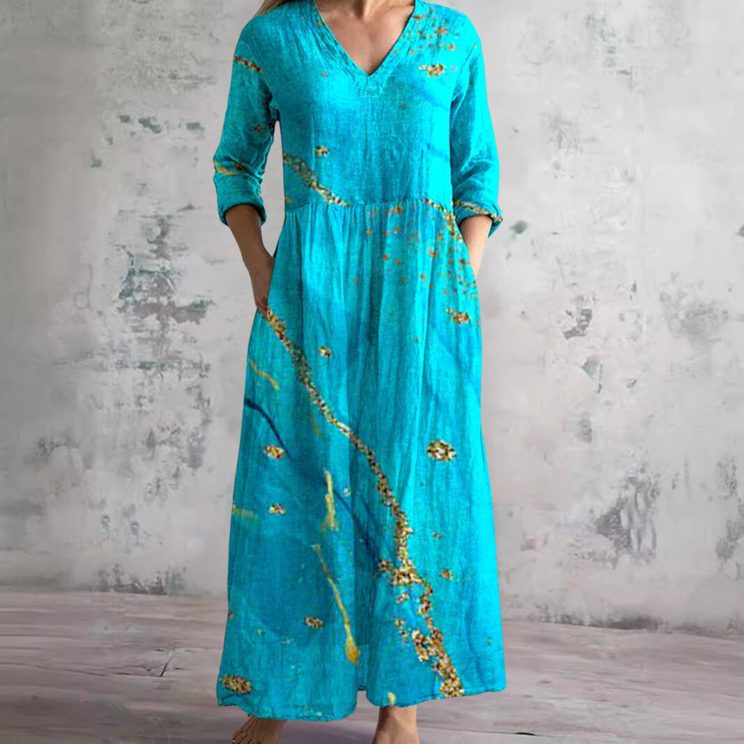 Abito fluido estivo da donna con stampa floreale colorata e scollo a V. Perfetto stile boho per le giornate calde.